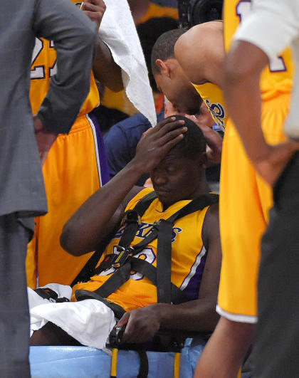 Lakers forward Julius Randle is removed on a stretcher Tuesday night. (AP Photo)