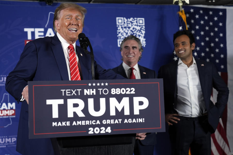 Republican presidential candidate former President Donald Trump speaks as former Republican presidential candidates, North Dakota Gov. Doug Burgum and Vivek Ramaswamy, appear on stage during a campaign event in Laconia, N.H., Monday, Jan. 22, 2024. (AP Photo/Matt Rourke)