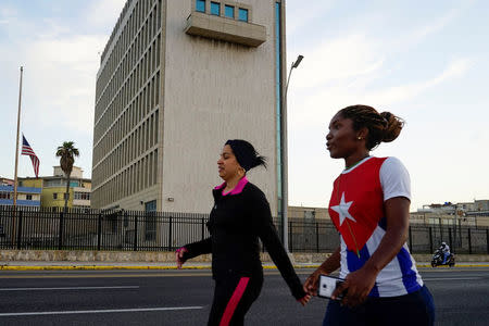 People walk past the U.S. Embassy in Havana, Cuba, April 19, 2018. REUTERS/Alexandre Meneghini