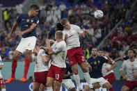 France's Raphael Varane he's the ball and makes an attempt to score during the World Cup group D soccer match between France and Denmark, at the Stadium 974 in Doha, Qatar, Saturday, Nov. 26, 2022. (AP Photo/Christophe Ena)