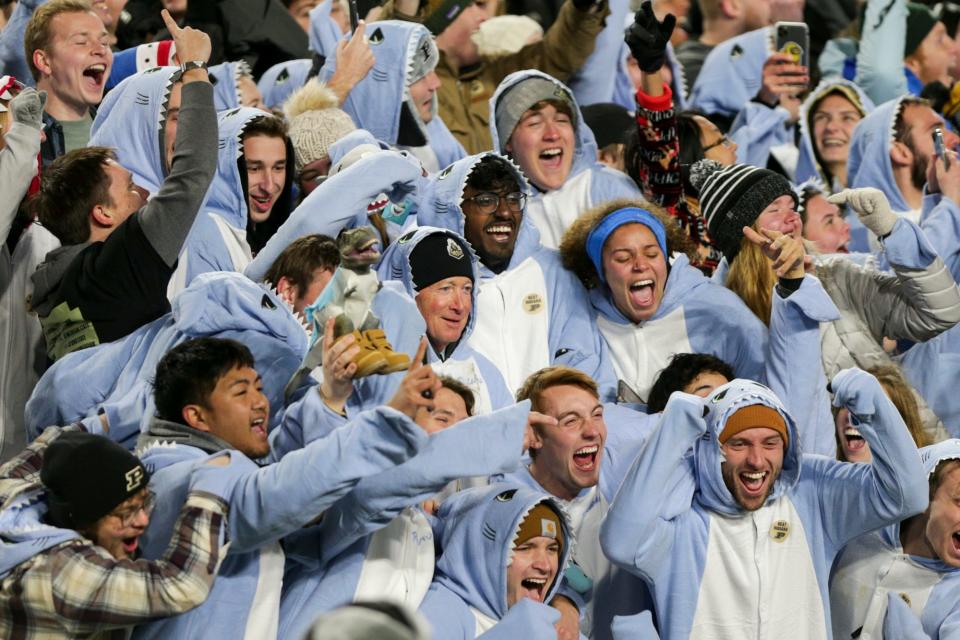 Purdue president Mitch Daniels hides in the student section during the third quarter of an NCAA college football game, Saturday, Nov. 27, 2021 at Ross-Ade Stadium in West Lafayette.