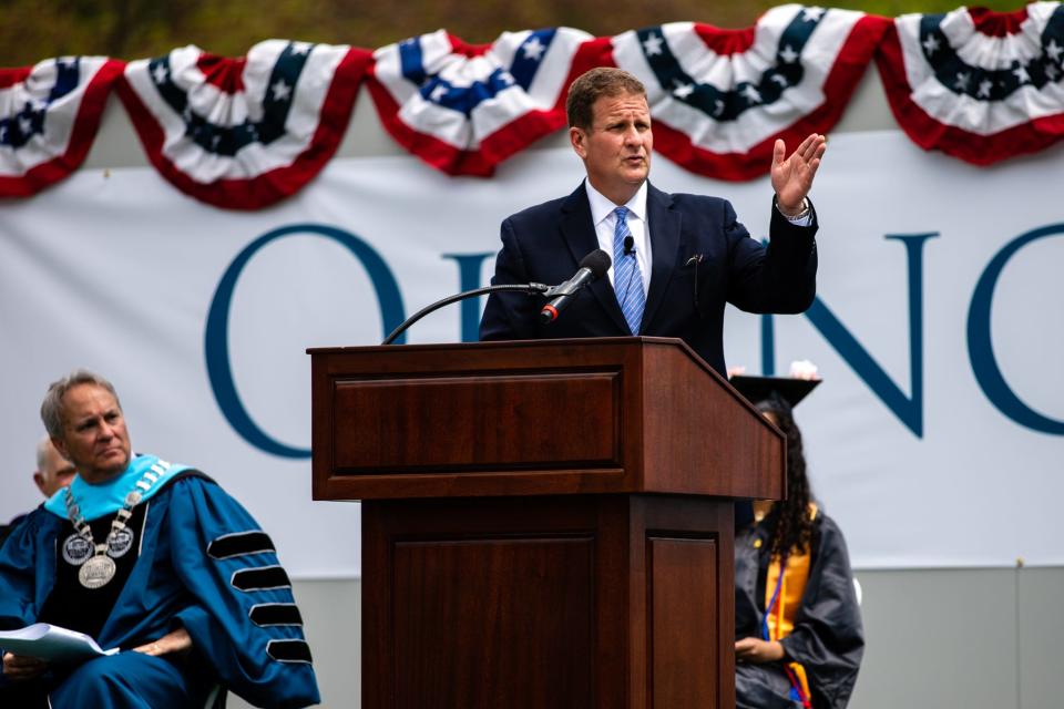 Rob Hale, president of Granite Telecommunications, gives a commencement address to Quincy College graduates at Veterans Memorial Stadium in Quincy on Friday, May 21, 2021.