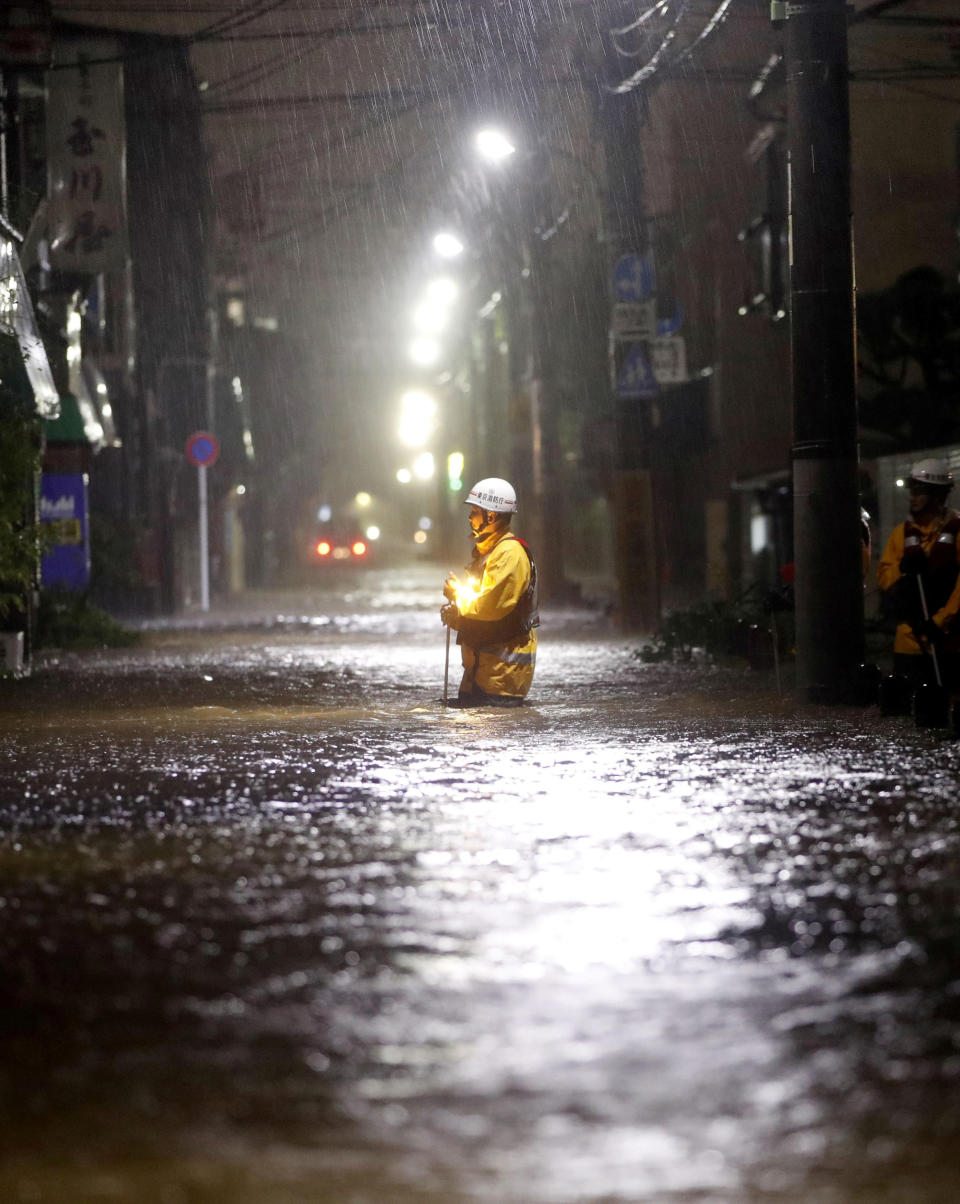 Firefighters patrol on a flooded road due to heavy rains caused by Typhoon Hagibis at Ota ward in Tokyo, Japan, October 12, 2019, in this photo taken by Kyodo Mandatory credit Kyodo/via REUTERS ATTENTION EDITORS - THIS IMAGE WAS PROVIDED BY A THIRD PARTY. MANDATORY CREDIT. JAPAN OUT.