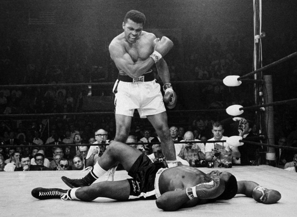 In this May 25, 1965, file photo, heavyweight champion Muhammad Ali stands over fallen challenger Sonny Liston, after dropping Liston with a short hard right to the jaw in Lewiston, Maine. (AP Photo/John Rooney, File)