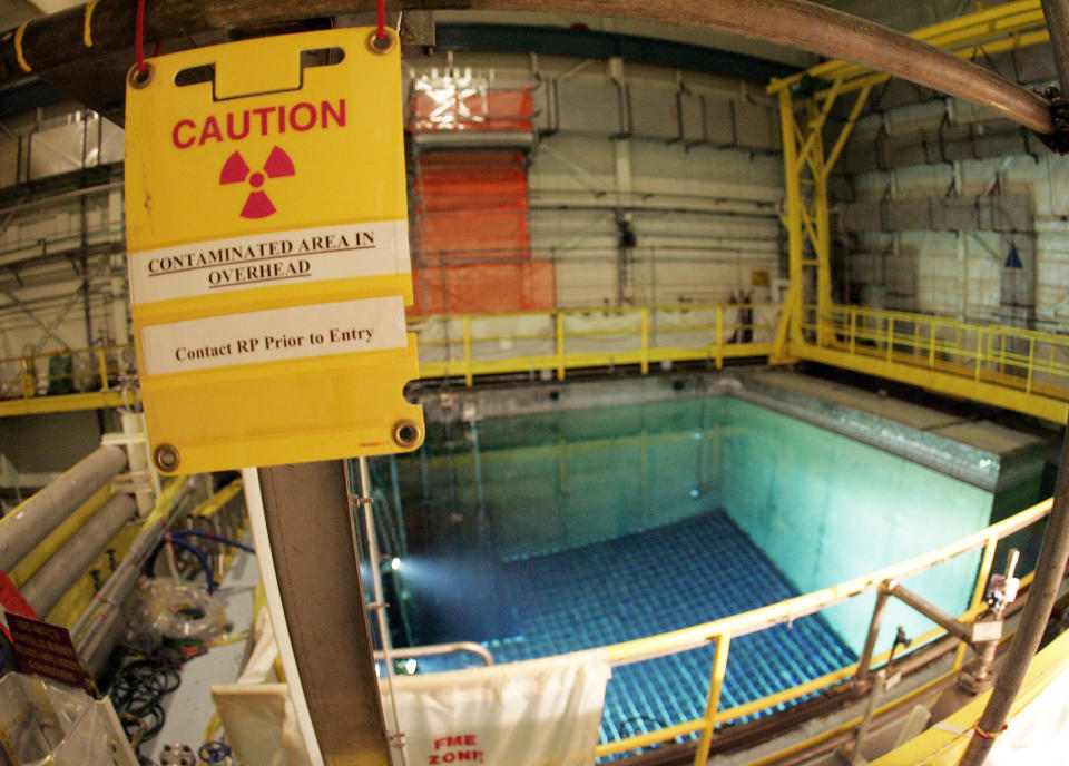 FILE — In this April 20, 2017, file photo, a caution sign marks an area surrounding a pool that protects spent nuclear fuel at the Indian Point Energy Center, in Buchanan, N.Y. Indian Point will permanently stop producing nuclear power Friday, April 30, 2021, capping a long battle over a key source of electricity for nearby New York City that opponents called a safety threat to millions in the densely packed metropolitan region. (AP Photo/Julie Jacobson, File)