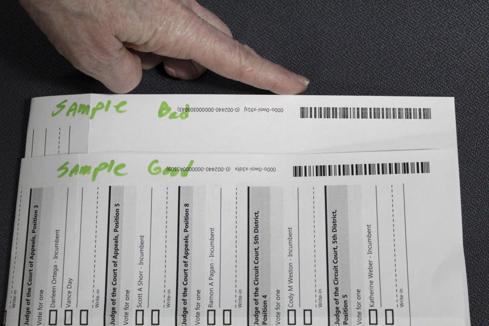 FILE— An election worker at the Clackamas County Elections office shows barcodes on ballots that is bad, top, and good on Thursday, May 19, 2022, Oregon City, Ore. Ballots with blurry barcodes that can't be read by vote-counting machines are delaying election results by weeks in a key U.S. House race in Oregon's primary. (AP Photo/Gillian Flaccus)