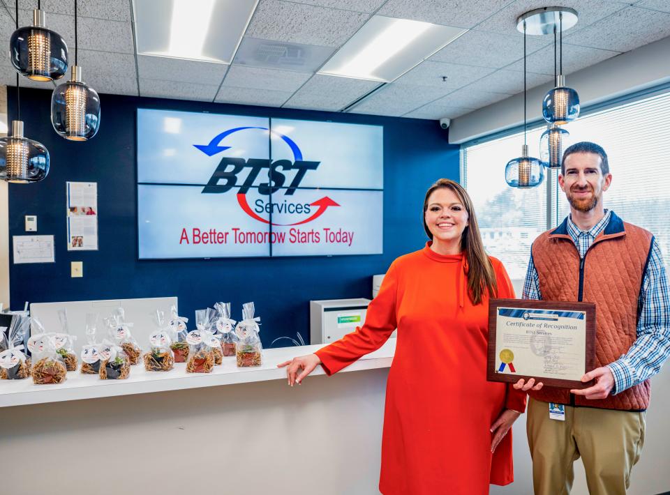 Washington County Business Development Director Jonathan Horowitz presents a certificate of recognition to BTST Services Clinical Director Tasha Walls during the organization's grand opening earlier this month. The bigger space in a Dual Highway office building provides room for group therapy sessions, Walls said.