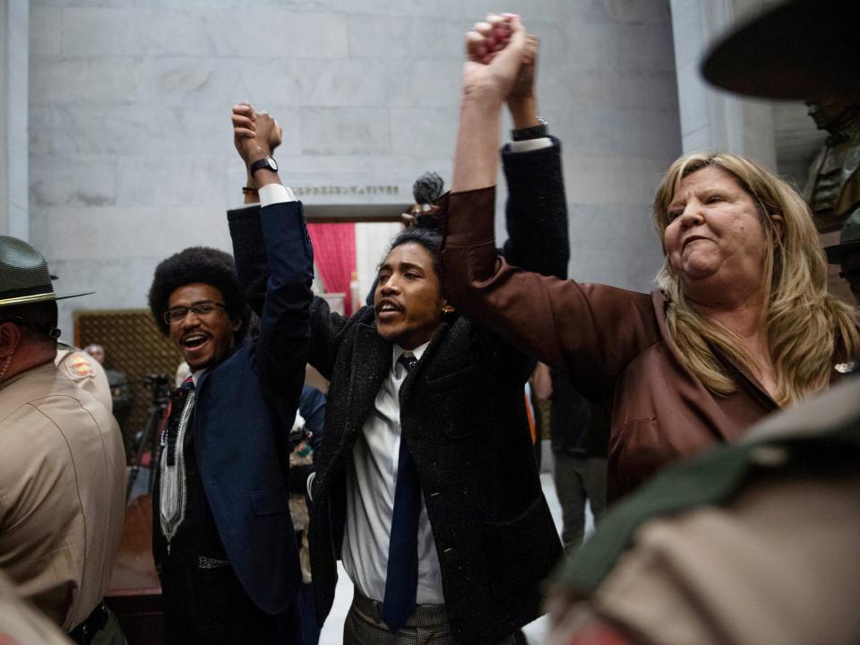 Rep. Justin Pearson, Rep. Justin Jones, Rep. Gloria Johnson People hold their hands up as they exit the House Chamber doors at the Tennessee State Capitol Building, in Nashville, Tennessee, U.S. April 3, 2023.
