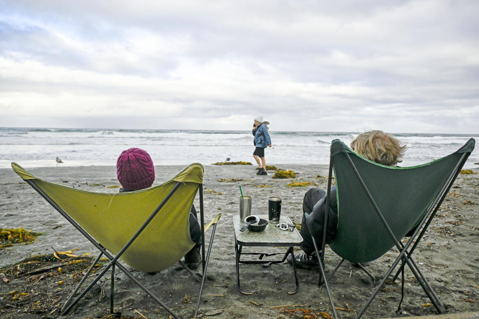 FILE - Elke Lindner, left, and Elke Lindner watch the surf at La Jolla Shore, Jan. 23, 2024, in La Jolla, Calif. For the eighth straight month, Earth was record hot, according to the European climate agency’s analysis of January 2024. (AP Photo/Denis Poroy, File)