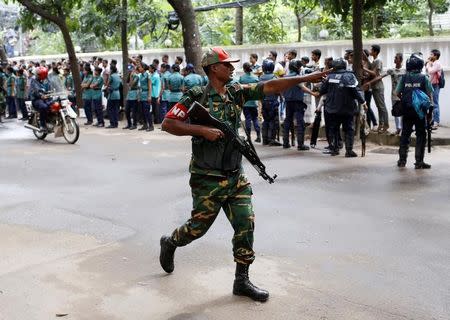 A security personnel reacts near the Holey Artisan restaurant after gunmen attacked the upscale cafe, in Dhaka, Bangladesh, July 2, 2016. REUTERS/Mohammd Ponir Hossain