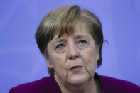 CORRECTS DAY German Chancellor Angela Merkel attends a news conference with Bavarian state governor Markus Soeder and the Mayor of Berlin Michael Mueller after a meeting at the chancellery in Berlin, Germany, Wednesday, March 3, 2021. German Chancellor Angela Merkel conferred with the governors of the country's 16 states to discuss how to move forward with coronavirus restrictions. (AP Photo/Markus Schreiber, Pool)