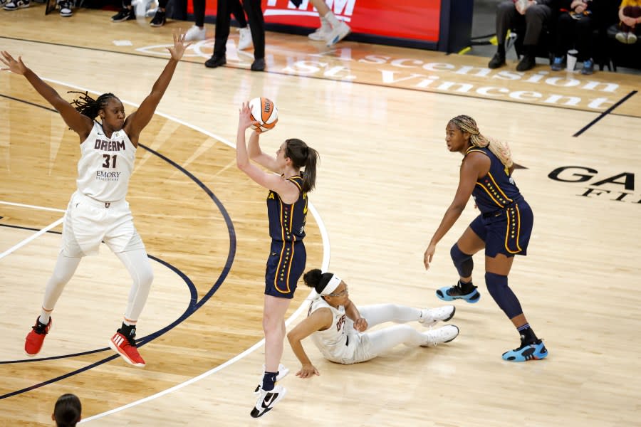 INDIANAPOLIS, IN – MAY 09: Indiana Fever guard Caitlin Clark takes a three point shot against Atlanta Dream center <a class="link " href="https://sports.yahoo.com/wnba/players/4613/" data-i13n="sec:content-canvas;subsec:anchor_text;elm:context_link" data-ylk="slk:Tina Charles;sec:content-canvas;subsec:anchor_text;elm:context_link;itc:0">Tina Charles</a> (31) during a WNBA preseason game on May 9, 2024, at Gainbridge Fieldhouse in Indianapolis, Indiana. (Photo by Brian Spurlock/Icon Sportswire via Getty Images)