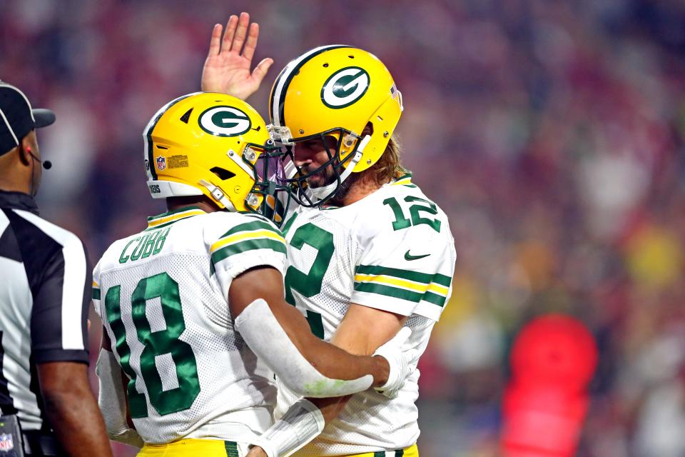 Green Bay Packers wide receiver Randall Cobb celebrates with quarterback Aaron Rodgers after catching a touchdown pass in the second half.