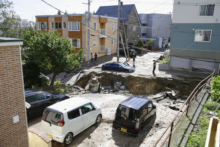 People look at an area damaged by an earthquake in Sapporo in Japan's northern island of Hokkaido, Japan, in this photo taken by Kyodo September 6, 2018. Mandatory credit Kyodo/via REUTERS