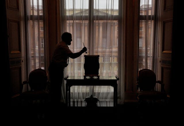 Final preparations with a staff member in silhouette