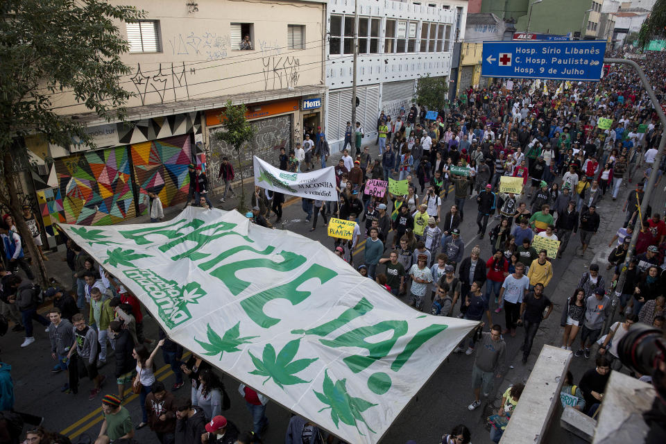 Demonstrators hold a banner that reads in Portuguese: "Legalize Now," during a legalization of marijuana march in Sao Paulo, Brazil, Saturday, April 26, 2014. Brazilian police say about 2,000 people have gathered in downtown Sao Paulo in a demonstration demanding the legalization of the production and sale of marijuana in Latin America's largest country. (AP Photo/Andre Penner)