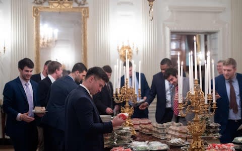 Guests select fast food in the State Dining Room of the White House  - Credit: SAUL LOEB/AFP