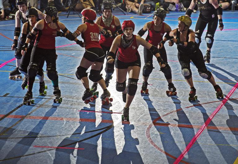 The DC Rollergirls (in red) take on the Rideau Valley Vixens from Ottawa, Canada during the women's flat track Roller Derby, April 5, 2014 at the Dulles Sportsplex in Sterling, Virginia