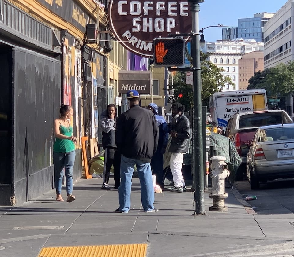 Drug dealers crowd the street corners around the Tenderloin's encampments.