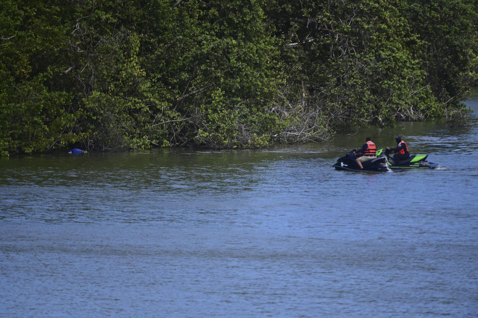 Authorities look at the body of 27-year-old Keishla Rodriguez in the San Jose lagoon after she was reported missing in San Juan, Puerto Rico, Saturday, May 1, 2021. A federal judge on Monday ordered Puerto Rican boxer Félix Verdejo held without bail after he was charged in the death of Rodriguez, his pregnant lover. (AP Photo/Carlos Giusti)