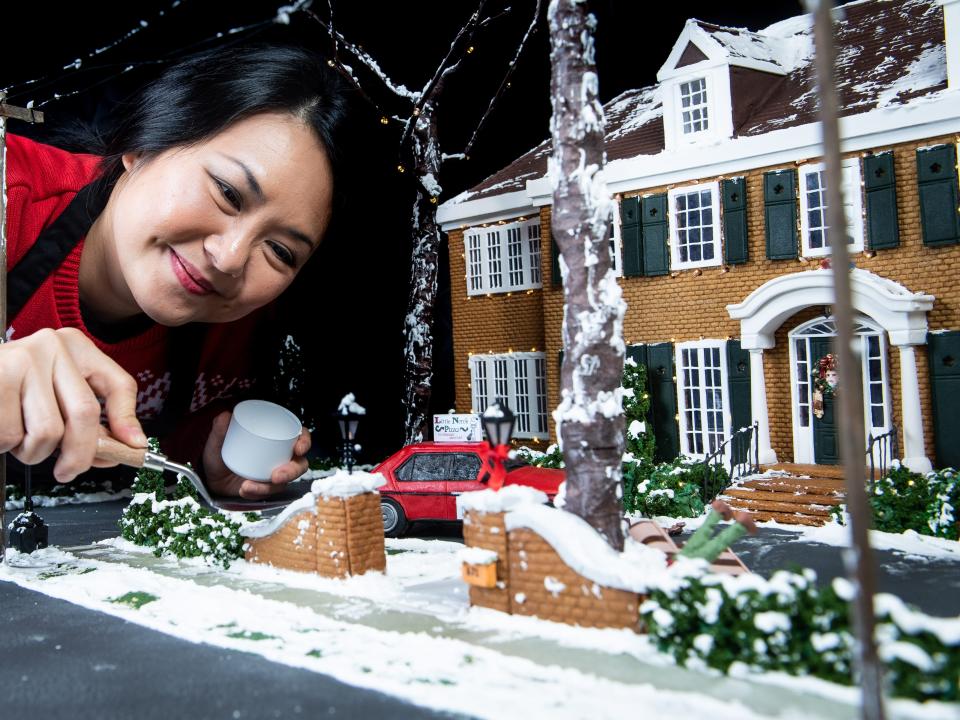 Cake designer Michelle Wibowo works on her gingerbread version of the McCallister house