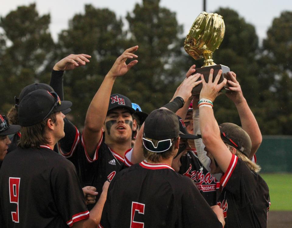 New Home celebrates with their trophy after sweeping Olton during their Region I-2A quarterfinal baseball series at Littlefield on Thursday, May 18, 2023.