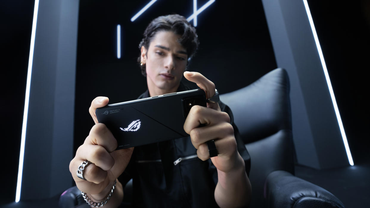  A person using the Asus ROG Phone 8 for mobile gaming. 