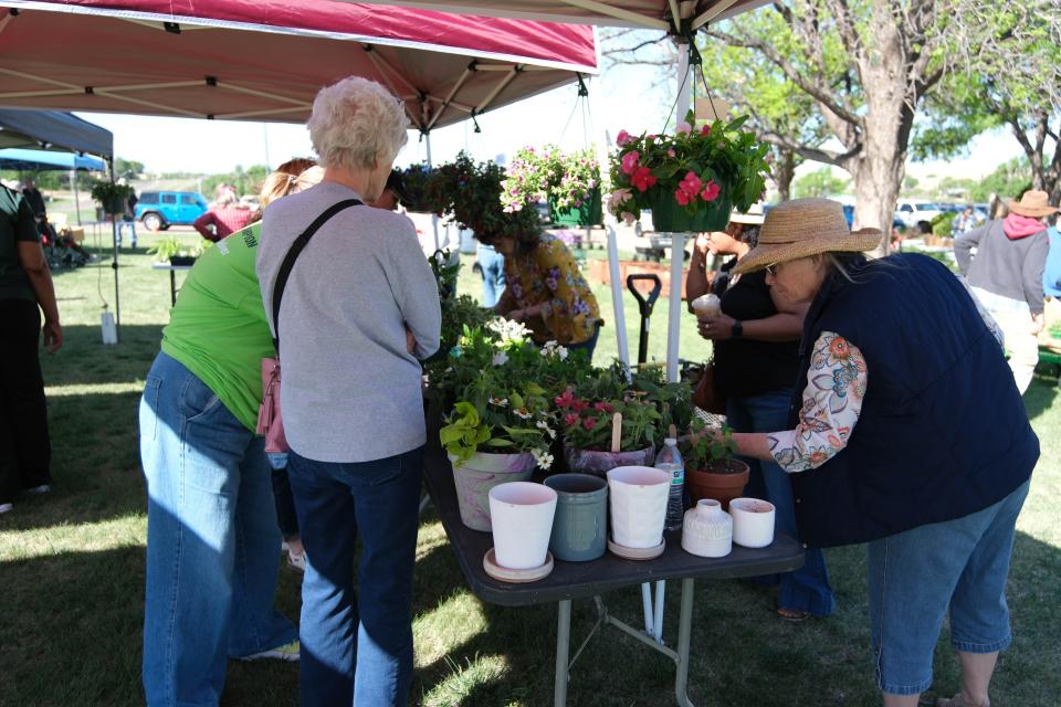 Customers look over various plants at the Randall County Master Gardeners plant sale Saturday as part of Gardenfest at the Texas A&M AgriLife Extension Center in Amarillo.