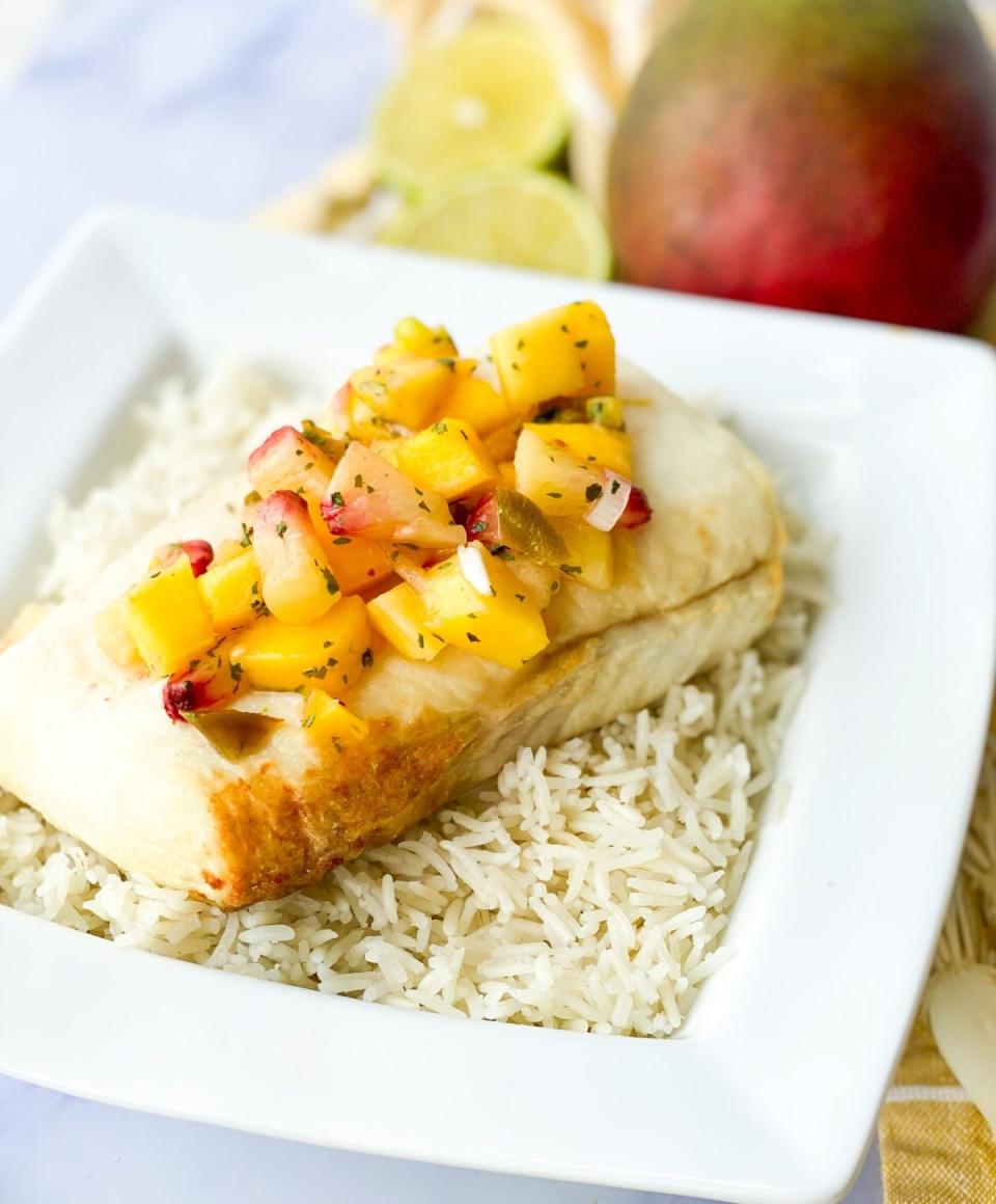 Halibut over rice topped with mango salsa.