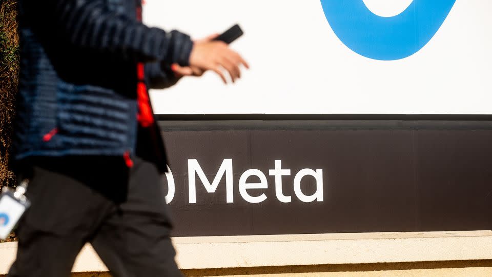 A person walks past a newly unveiled logo for "Meta", the new name for Facebook's parent company, outside Facebook headquarters in Menlo Park on October 28, 2021. - Noah Berger/AFP/Getty Images