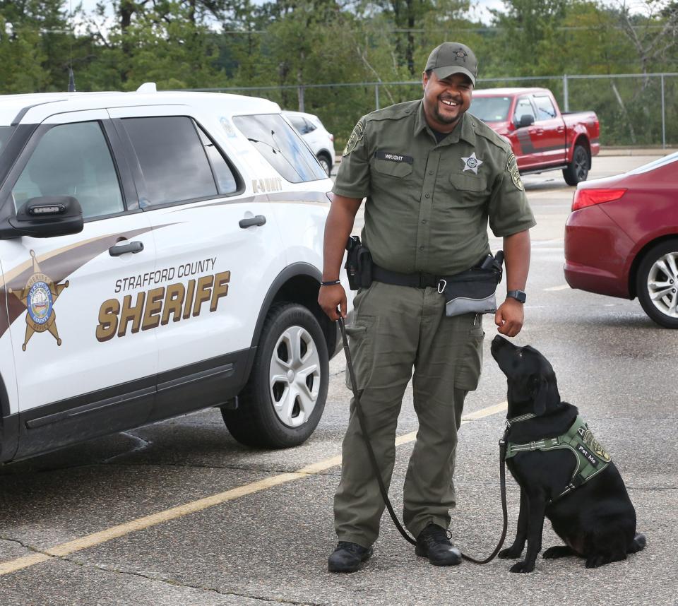 Strafford County sheriff's Deputy Josh Wright works with Cara, a Labrador retriever who serves as a comfort dog.