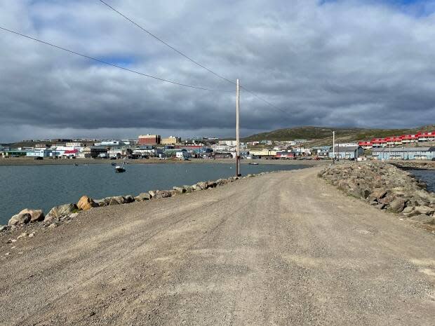A view of Iqaluit from the breakwater in July of 2021. Traveling out of and back to Nunavut just got a lot easier for parents in the territory. Their children will now be able to self-isolate at home, and vaccinated parents will not have to isolate with them.  (David Gunn/CBC - image credit)