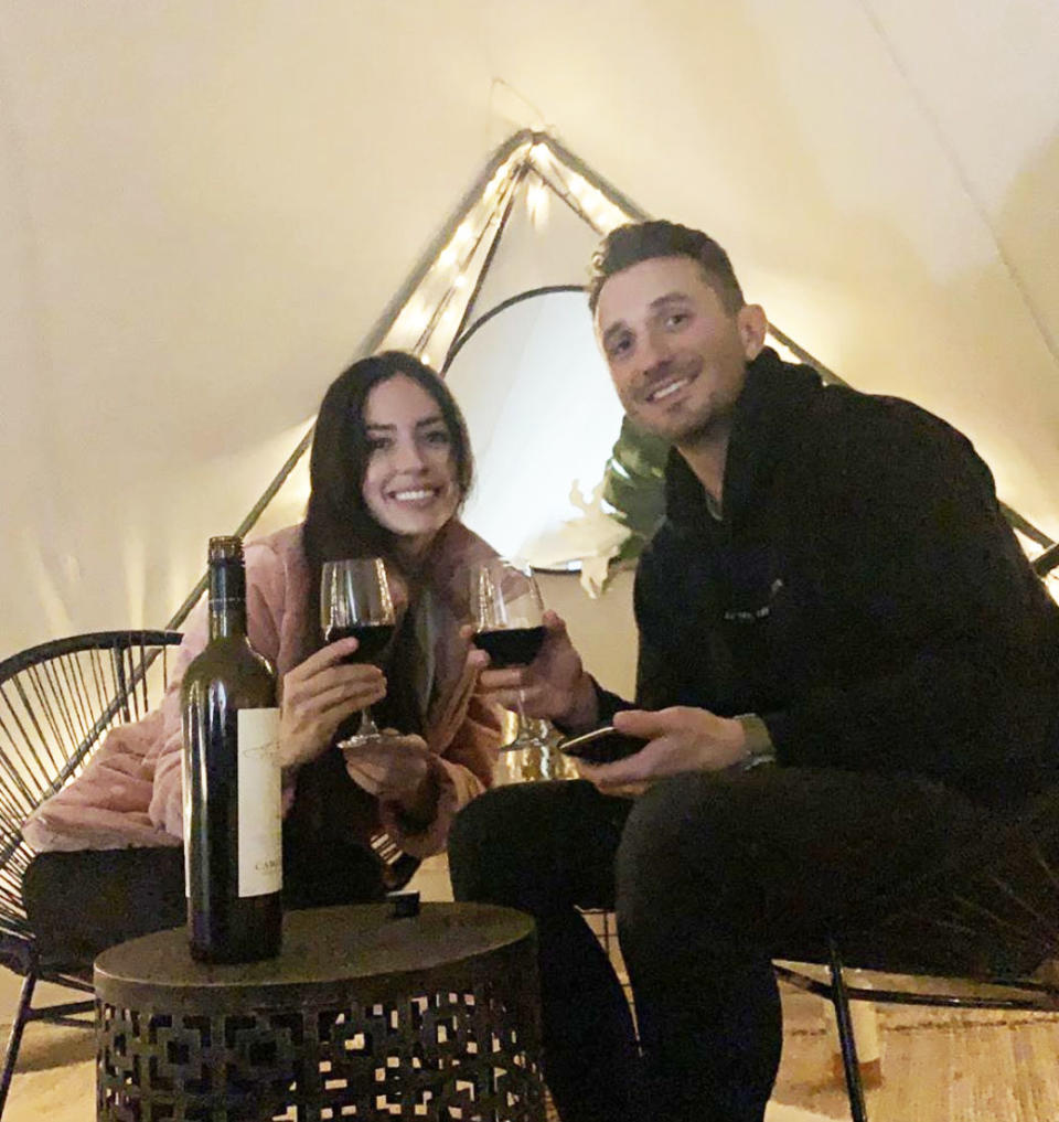 The Project's Tommy Little and his new girlfriend Natalie Kyriacou drinking wine in a tent in Gippsland, Victoria.