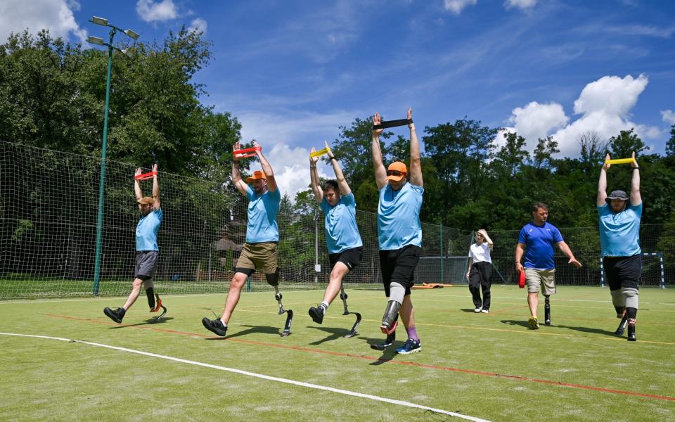 Patients at the Superhumans Center exercise during an event held, in part, to test new German-manufactured running blades