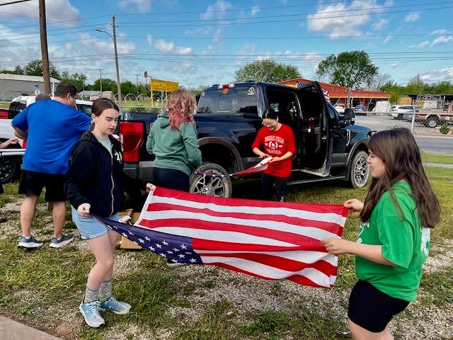 Who: 30 Southwest Rotarians, Road to College mentors and families. What: 800 flags inspected, repaired and readied for community holiday display subscribers.