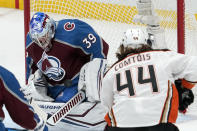 Colorado Avalanche goaltender Pavel Francouz, left, stops a shot by Anaheim Ducks left wing Max Comtois during the first period of an NHL hockey game Wednesday, Jan. 19, 2022, in Anaheim, Calif. (AP Photo/Mark J. Terrill)