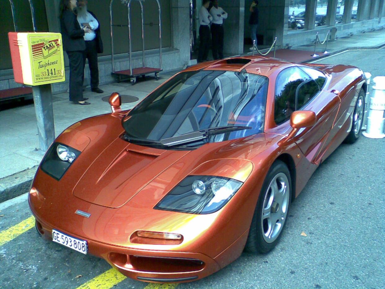 Rust colored McLaren F1 parked on street in Geneva, Switzerland