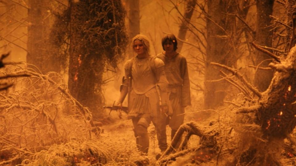 Galagriel and Theo walk through a forest covered in ash in The Rings of Power
