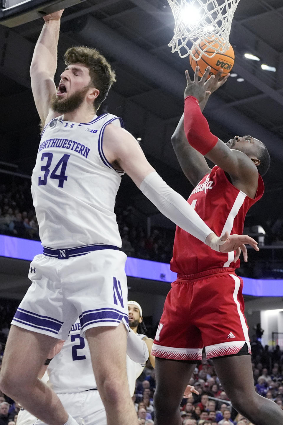 Nebraska forward Juwan Gary, right, shoots against Northwestern center Matthew Nicholson during the first half of an NCAA college basketball game in Evanston, Ill., Wednesday, Feb. 7, 2024. (AP Photo/Nam Y. Huh)