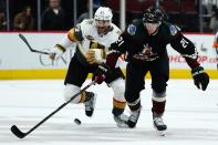 Arizona Coyotes left wing Loui Eriksson (21) keeps the puck away from Vegas Golden Knights left wing Max Pacioretty (67) during the first period of an NHL hockey game Friday, Dec. 3, 2021, in Glendale, Ariz. (AP Photo/Ross D. Franklin)