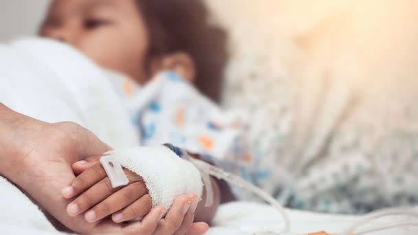 PHOTO: A mother holds her child's hand while she is hospitalized, in a stock image. (STOCK PHOTO/Getty Images)