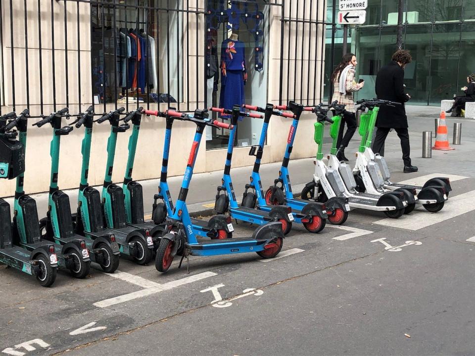 E-scooters from three different suppliers are parked in a designated parking space in Paris, France.