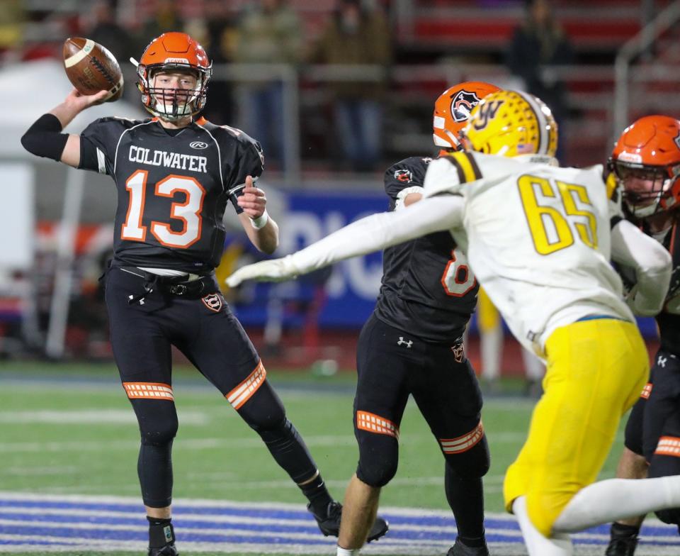 Coldwater's Reece Dellinger attempts a pass against West Jefferson during a Division VI state semifinal Nov. 27 at Piqua.