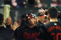 Baltimore Orioles' Adley Rutschman celebrates scoring off a double hit by Ryan O'Hearn during the fifth inning of a baseball game against the Los Angeles Angels, Tuesday, April 23, 2024, in Anaheim, Calif. Jackson Holliday also scored. (AP Photo/Ryan Sun)