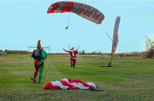 Santa and his Elves parachuting in to kick off Opening Day of Holiday in the Gardens.