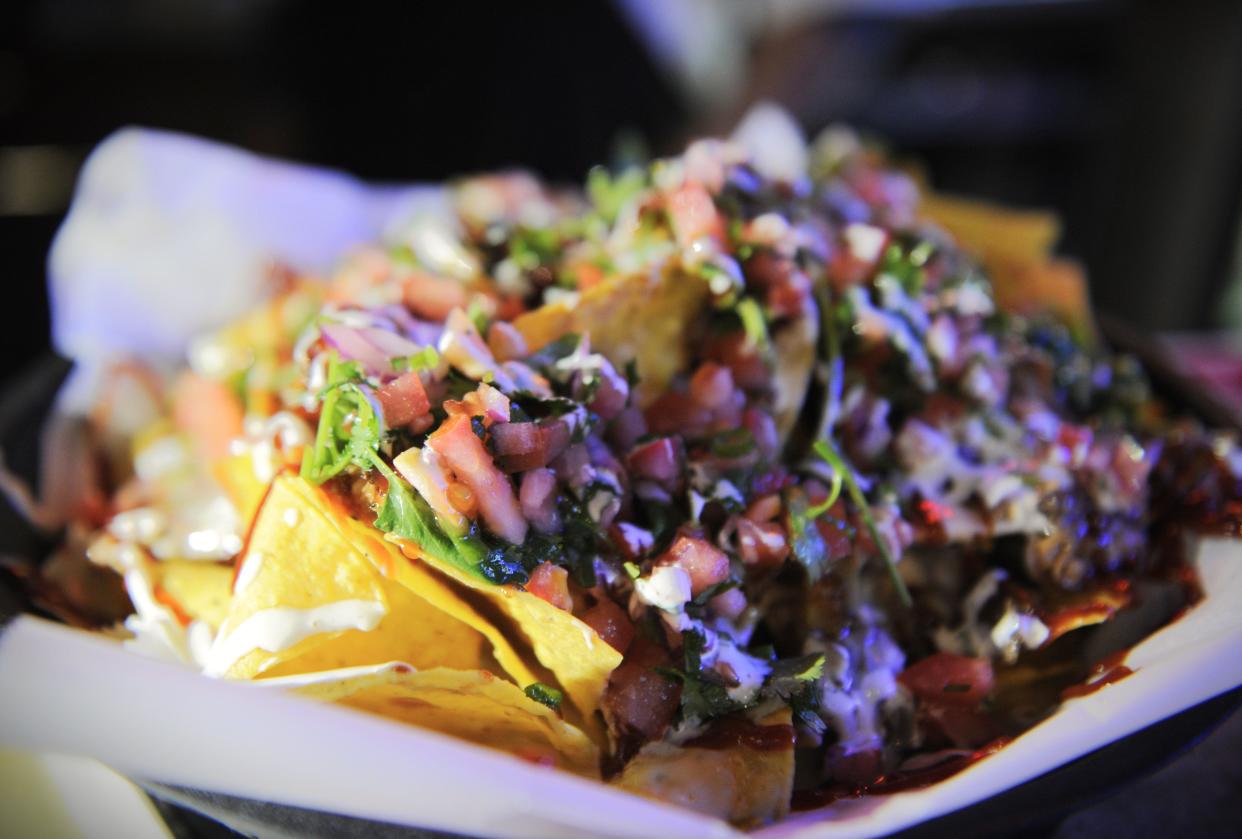 An order of nachos with savory house-braised pulled pork, fresh veggies, sour cream and more are served at the Lamasco Bar & Grill on Tuesday, Jan. 24, 2024.