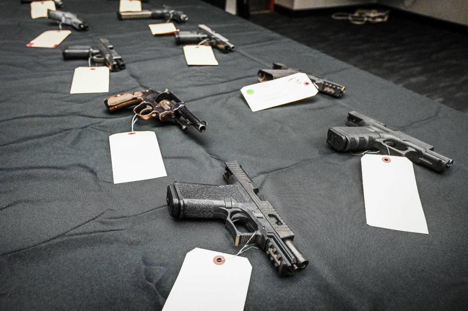 Confiscated guns are laid out for the media during a press conference to update the media on the recent multi-agency Operation Safe Neighborhoods, at the Fresno Police Department on Tuesday, May 24, 2022.