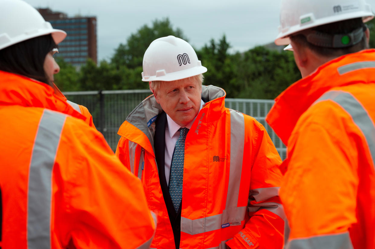 Britain's Prime Minister Boris Johnson reacts as he meets engineering graduates on the site of an under-construction tramline in Stretford, near Manchester, Britain July 27, 2019. Geoff Pugh /Pool via REUTERS