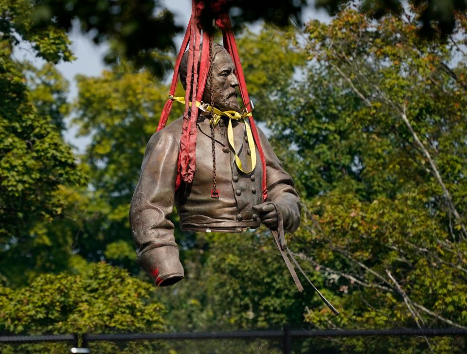 A section of the statue of Confederate Gen. Robert E. Lee in Richmond, Va., is suspended by straps as it is moved to a truck for removal on Wednesday, Sept. 8, 2021.