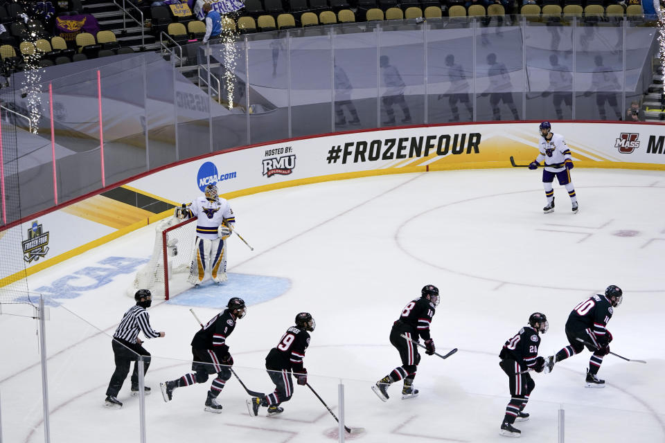 The St. Cloud State team follows Kyler Kupka (10) off the ice after he scored on Minnesota State goaltender Dryden McKay (29) during the first period of an NCAA hockey semifinal game at the Frozen Four in Pittsburgh, Thursday, April 8, 2021. (AP Photo/Keith Srakocic)